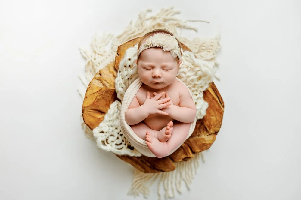 Newborn photography in Austin, Texas by Breeanna Rose Photography. Wooden bowl overhead.