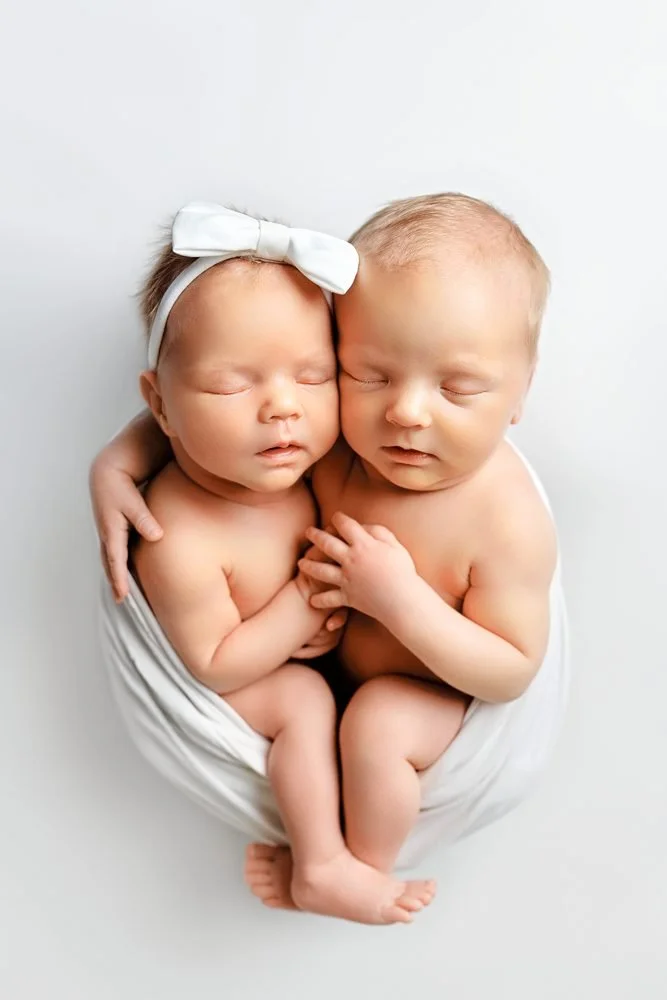 Newborn photography in Austin, Texas by Breeanna Rose Photography. Twins with a white bow.