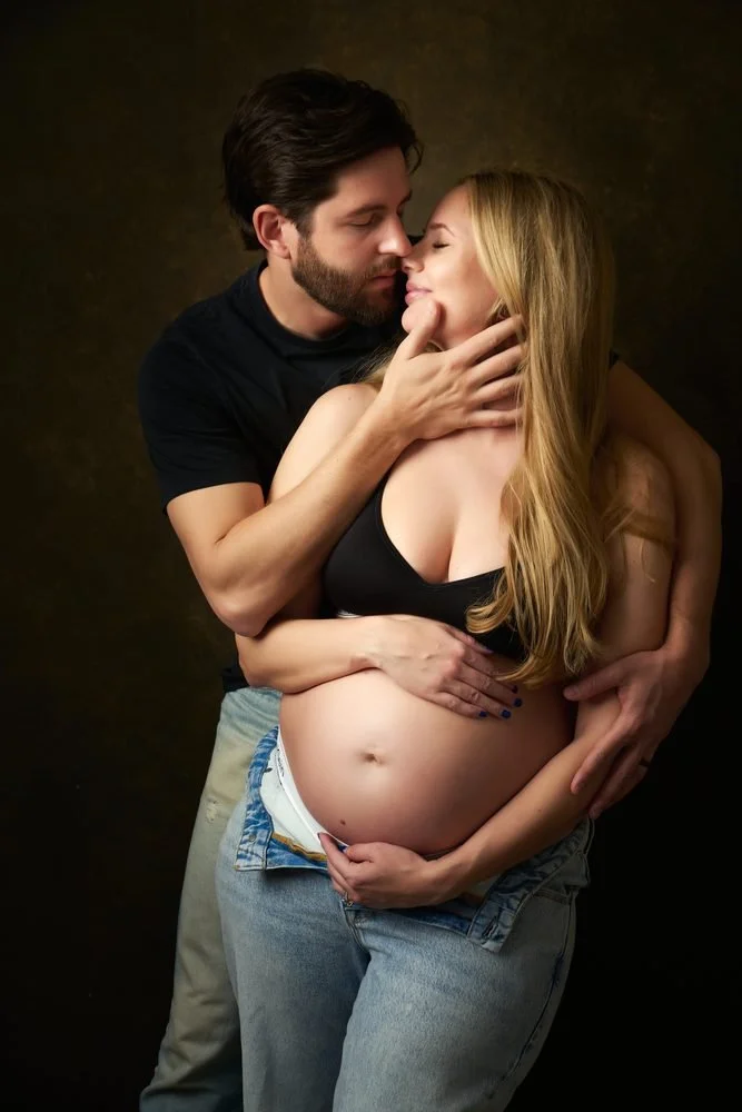 Maternity photography in Austin, Texas by Breeanna Rose Photography. Starred couple portrait, dark backdrop.