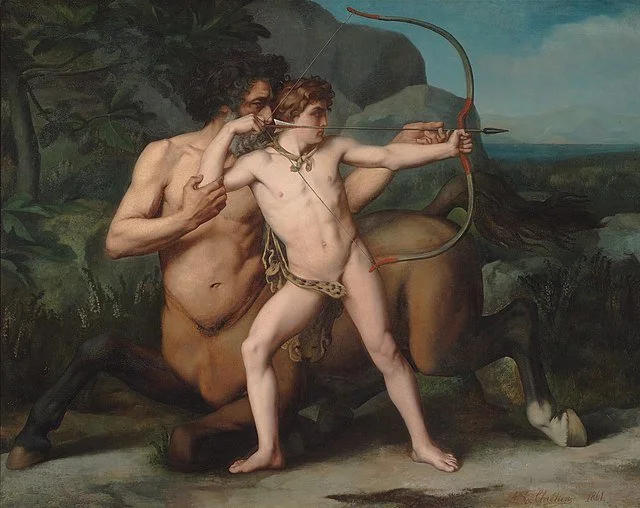 A scene inspired by mythology depicts a centaur with the upper body of a man and the lower body of a horse, guiding a young boy who is aiming a bow and arrow. The background shows a natural landscape with trees and hills.