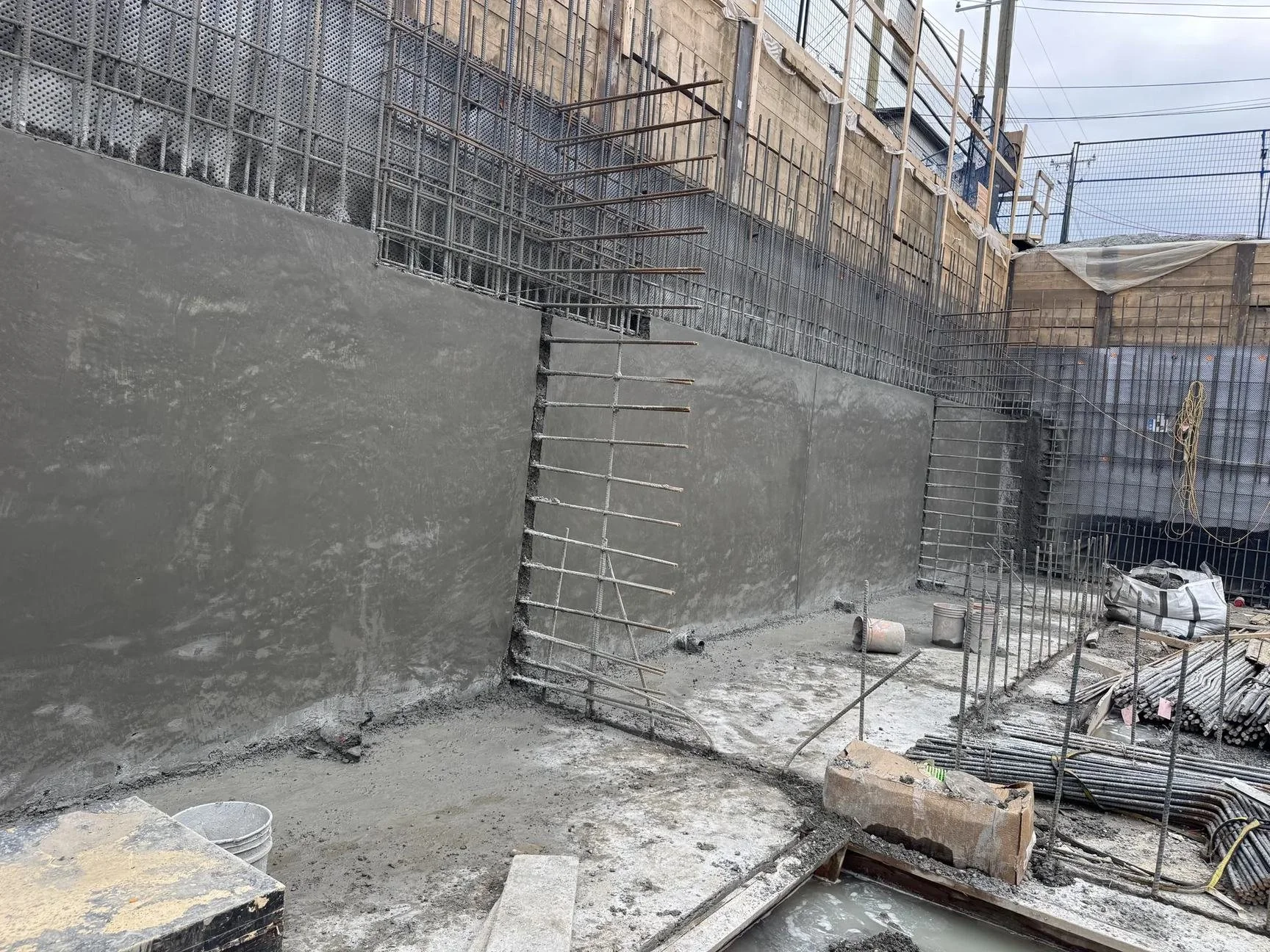 Structural shotcrete foundation wall with reinforcing steel on a building site