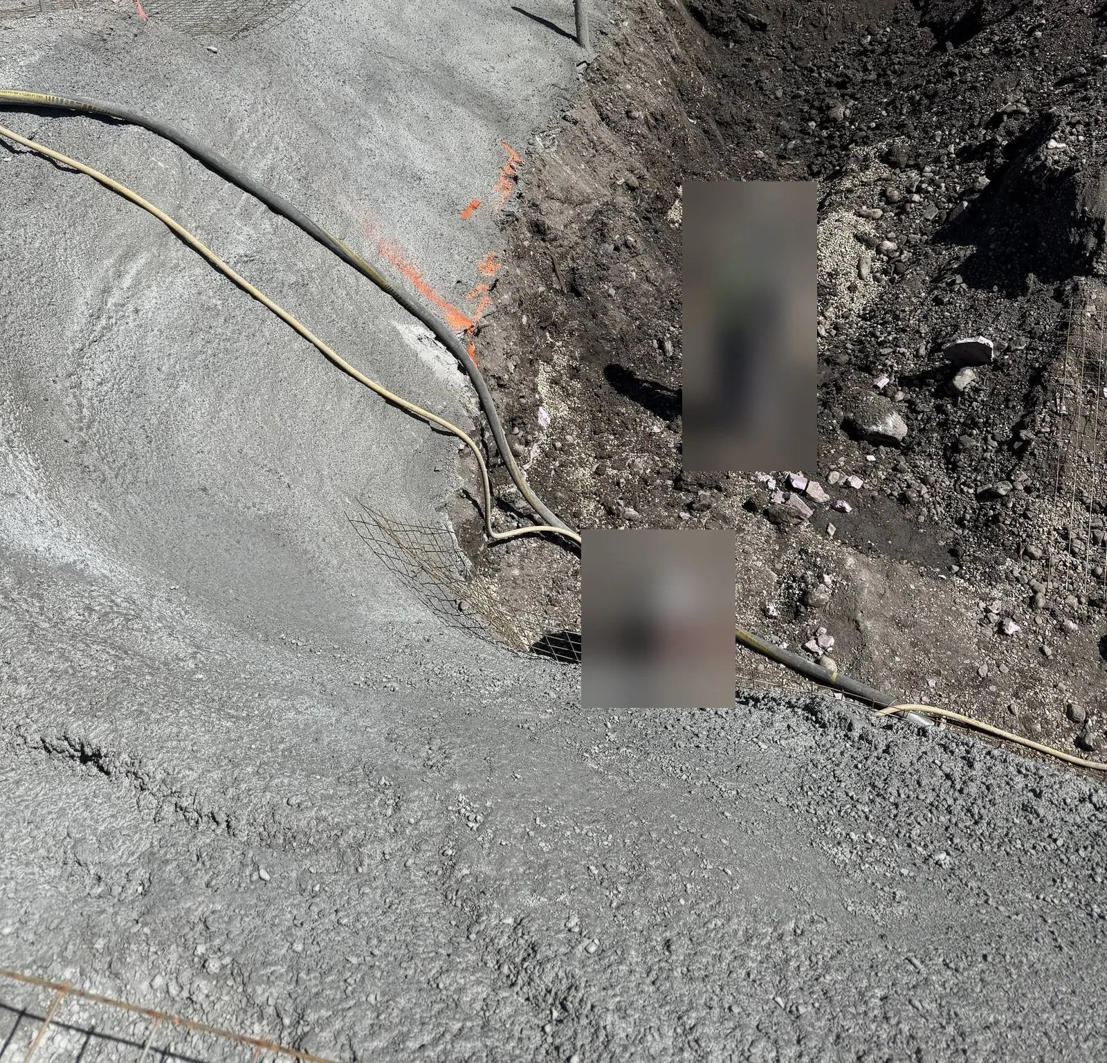 Shotcrete facing over wire mesh on a sloped excavation cut