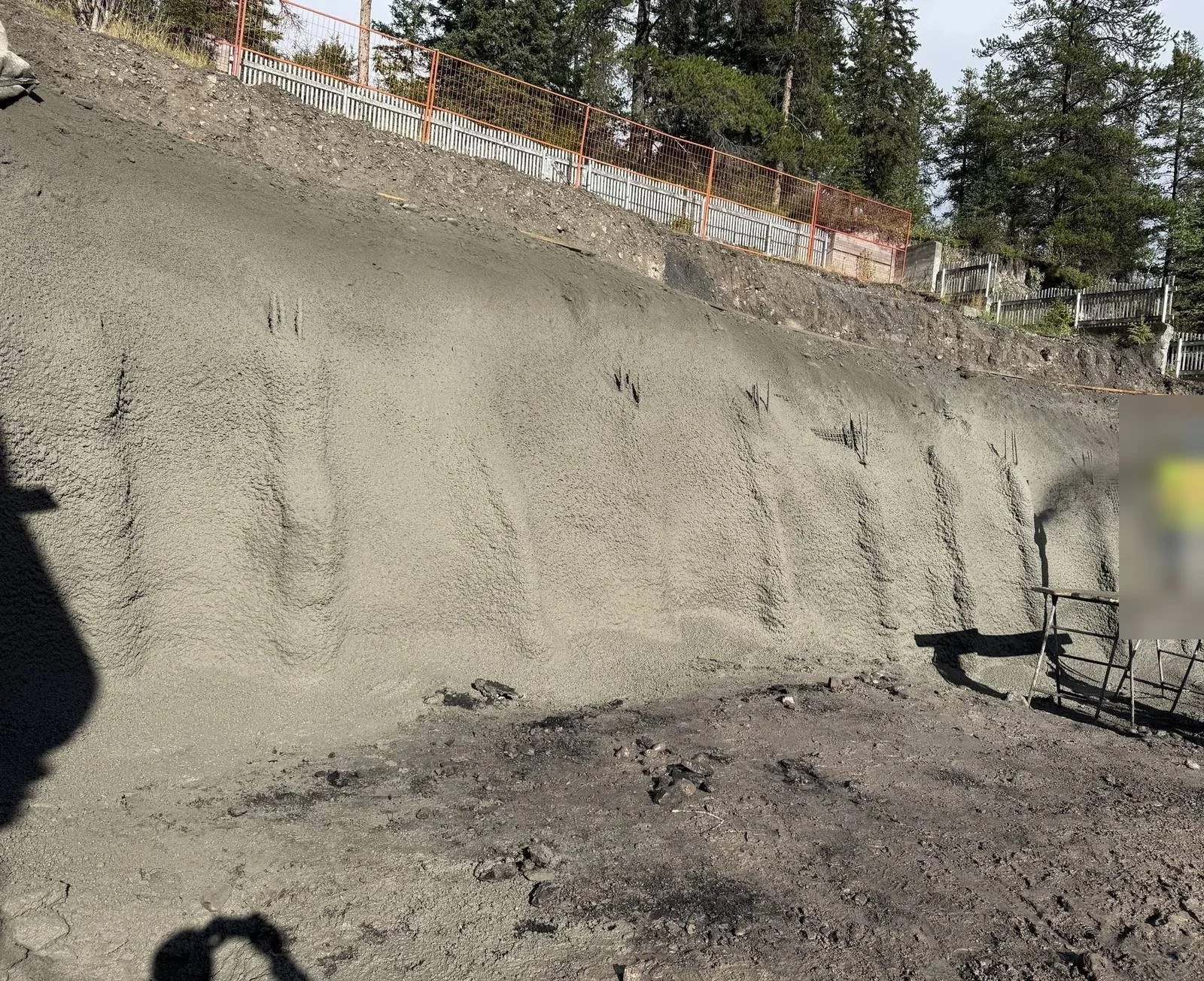 Finished shotcrete wall with pilasters along a deep residential excavation, Alberta