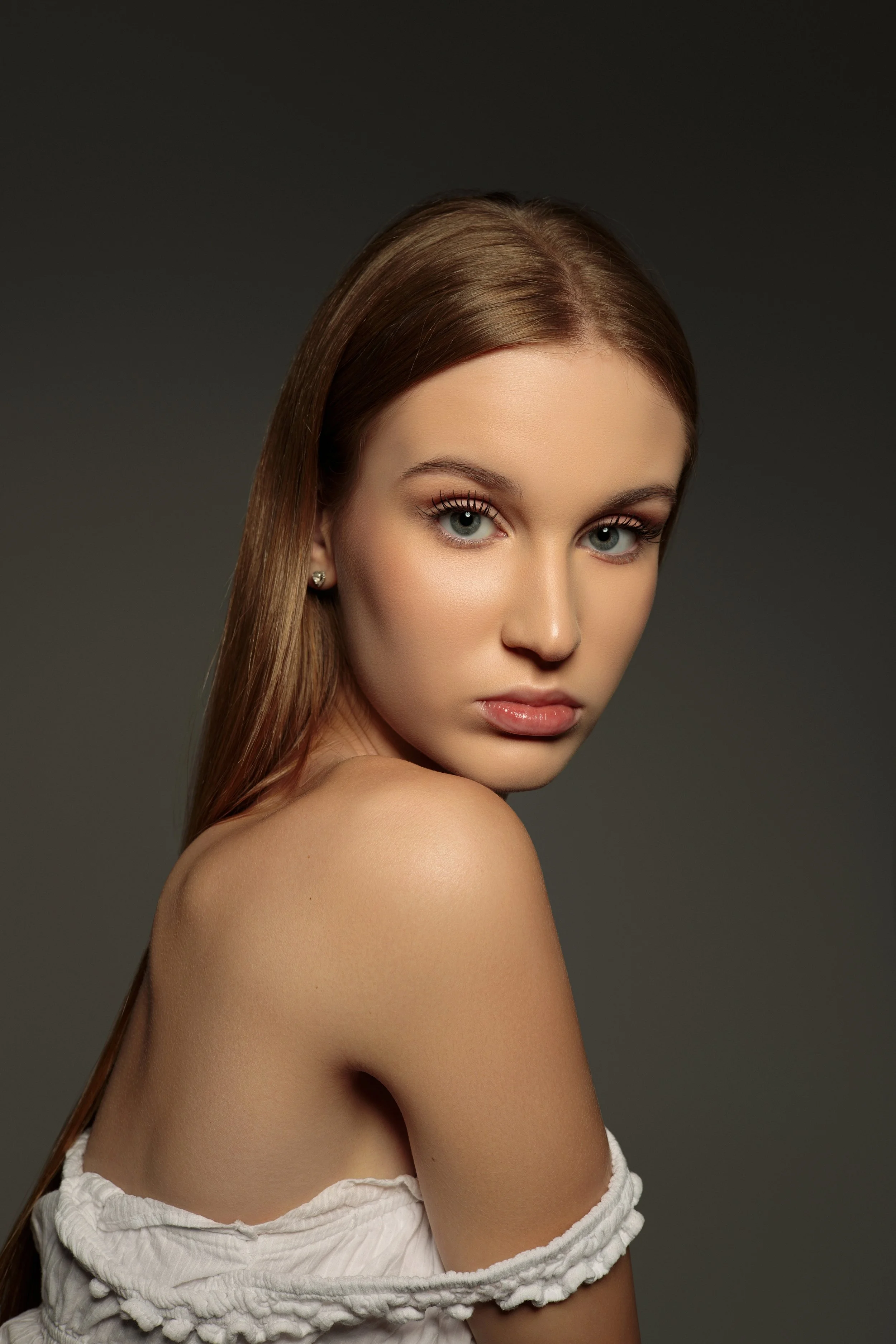 Victoria, female fashion model represented by Noirvelle Models, photographed in a close-up beauty portrait against a neutral background.
