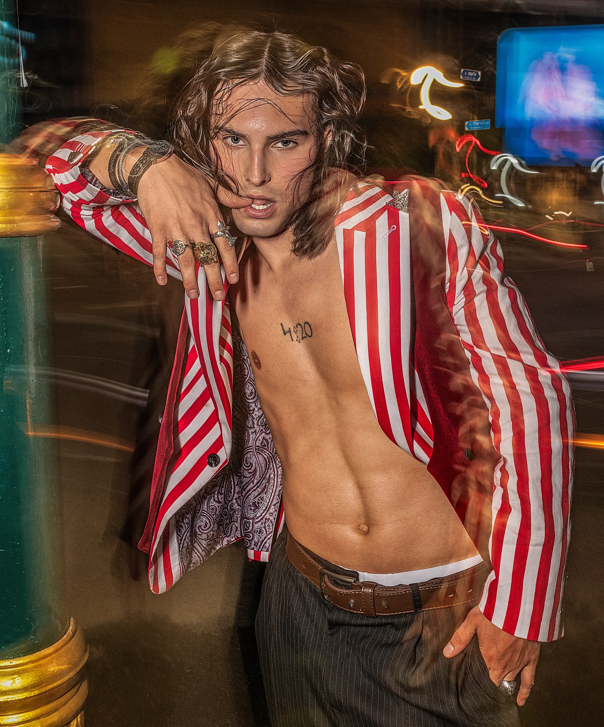 Konstantin Churakov — male fashion model represented by Noirvelle Models, featured in a fashion editorial with dramatic styling and neon lighting