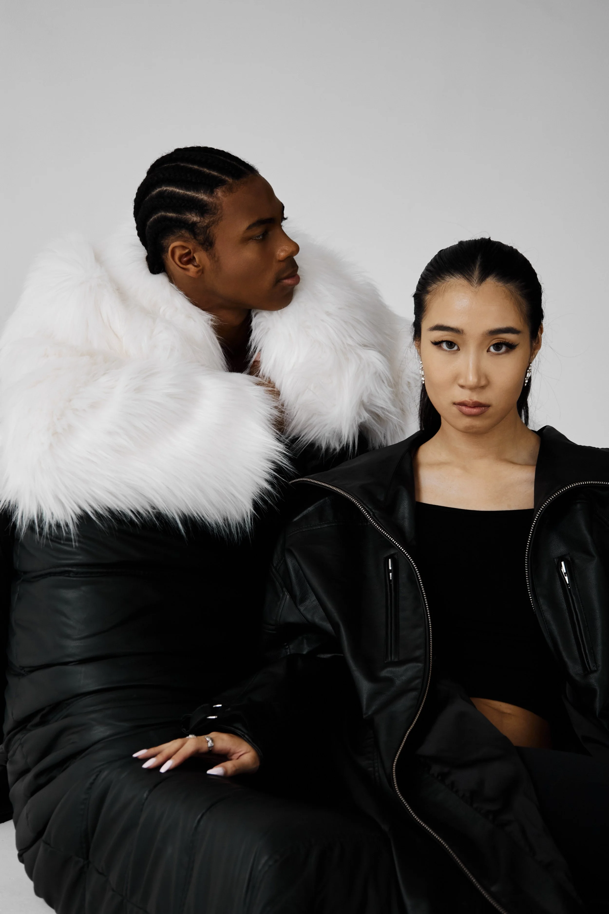 Joline and Jahvante, fashion models represented by Noirvelle Models, posing together in a studio editorial fashion photoshoot.