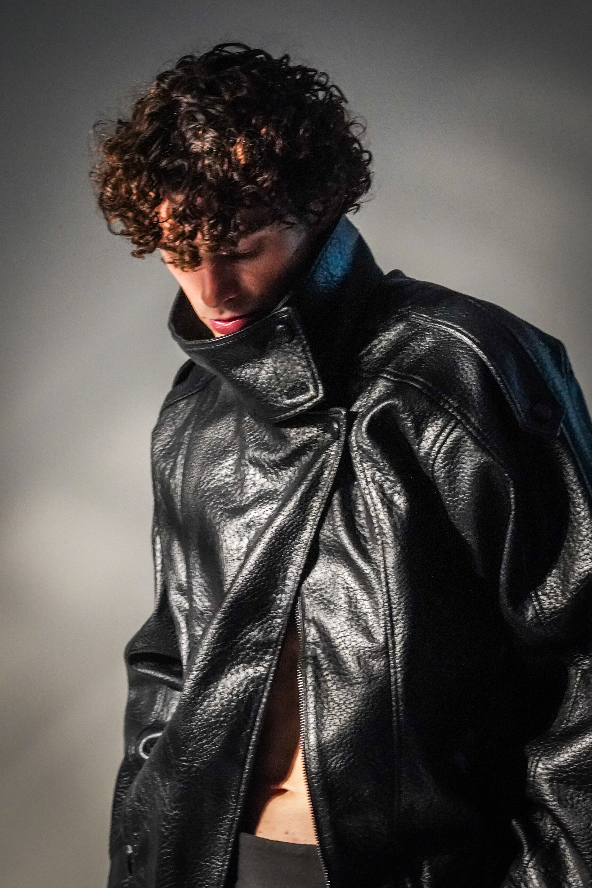 Maverick, male fashion model represented by Noirvelle Models, wearing a black leather jacket in an editorial portrait.
