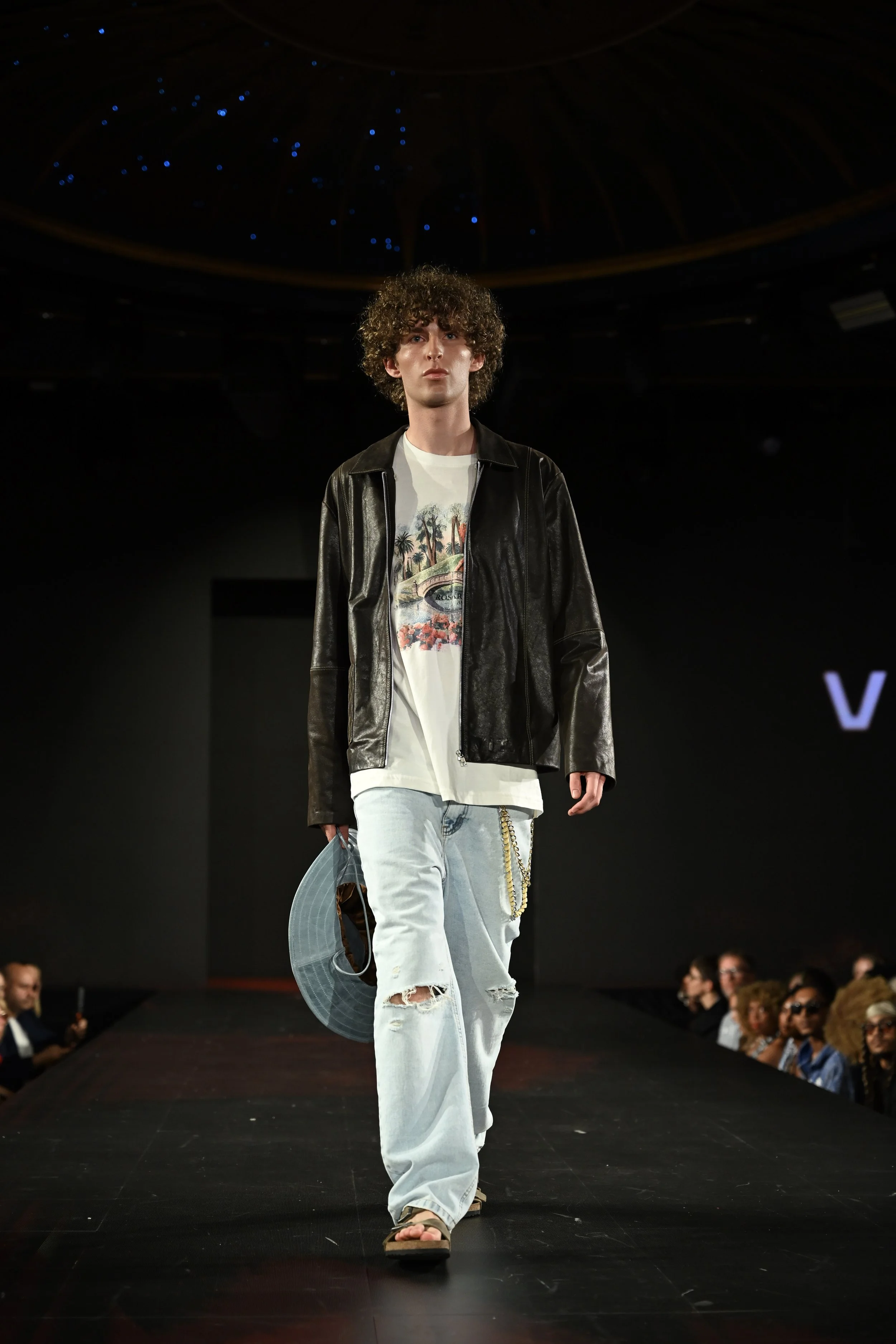  Andrea, male fashion model represented by Noirvelle Models, walking the runway during a fashion show.
