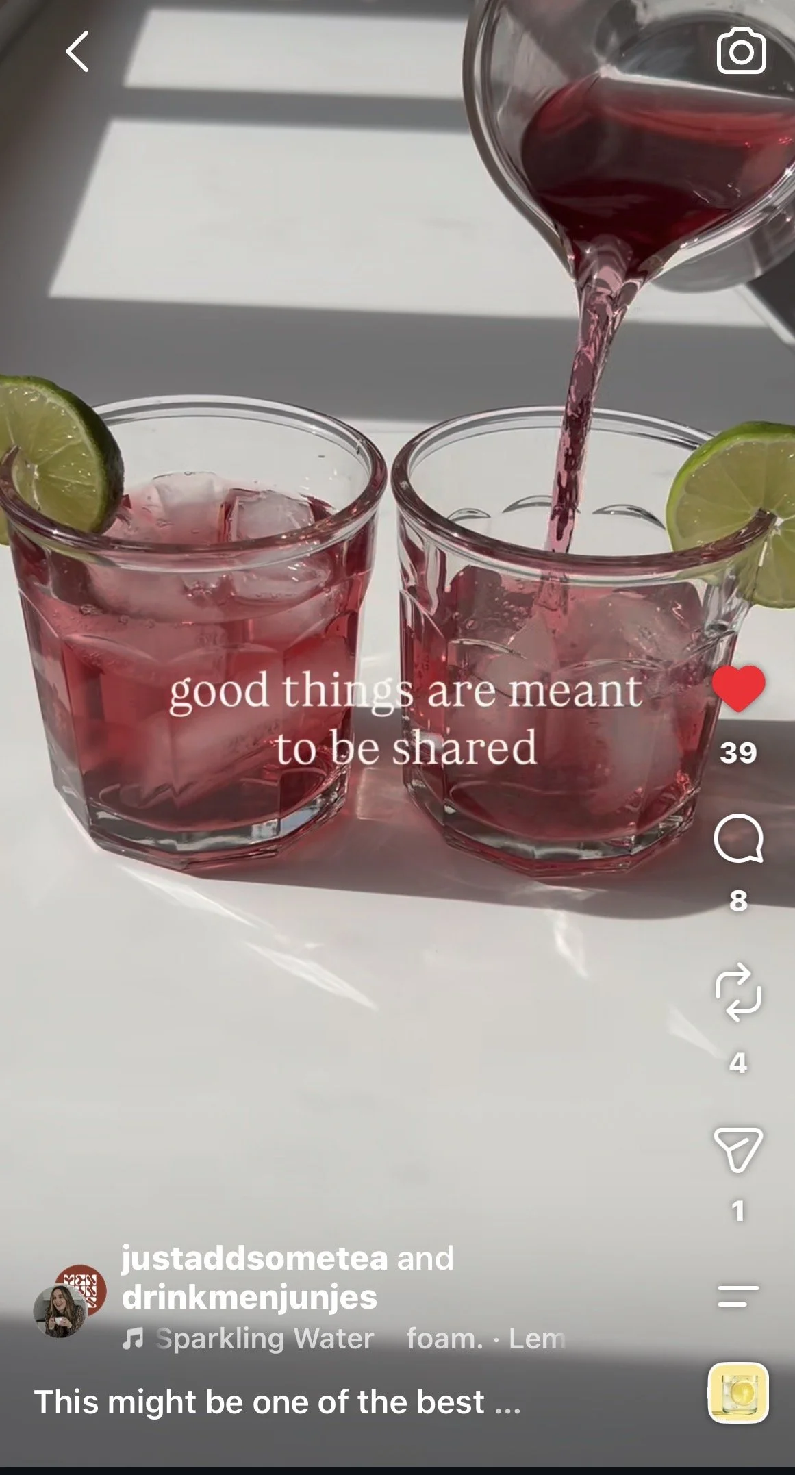 Two glasses of tea mocktail with ice and lime wedges, one being filled with pink tea infusion. Captured on a white surface with sunlight shadows — ideal for tea‑based beverages, wellness drinks, and summer tea recipes.