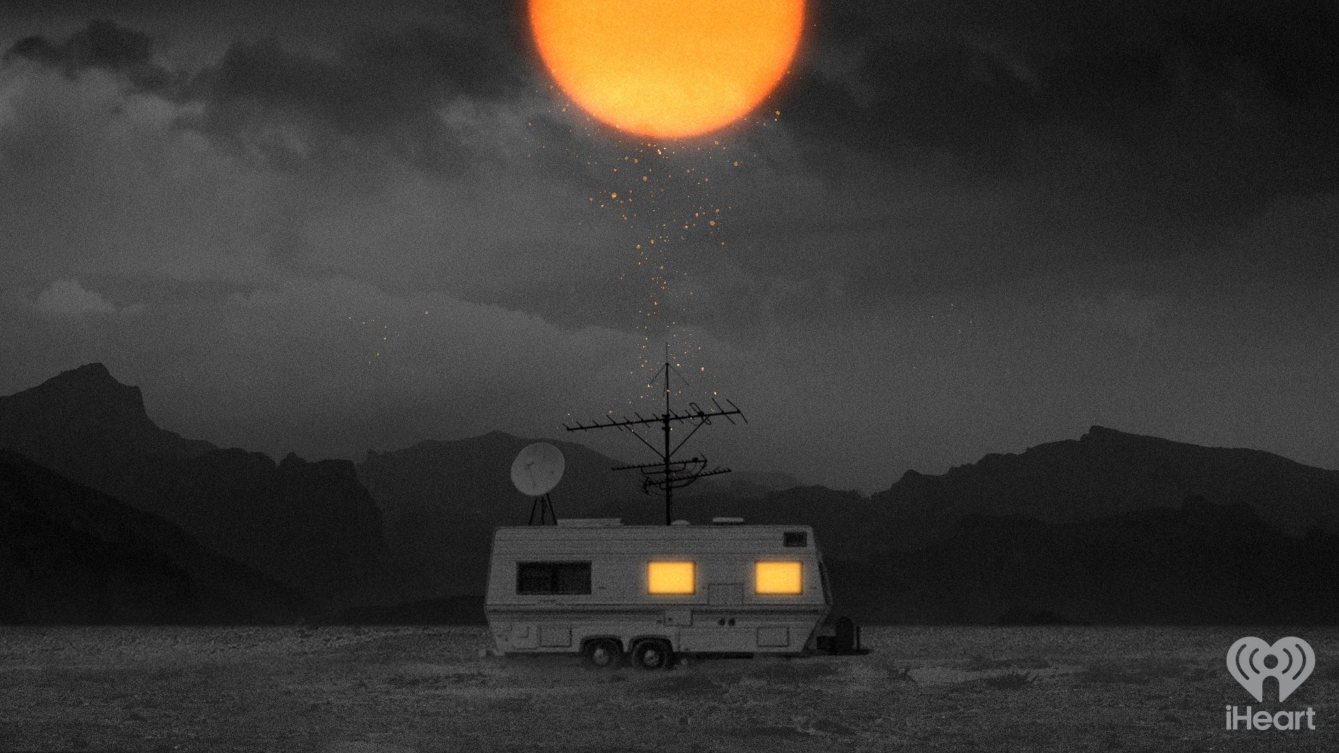 A caravan with lit windows parked on a barren landscape. The sky is dark with heavy clouds, and the moon is brightly shining. The caravan has antennas on the roof, and mountains are visible in the background.