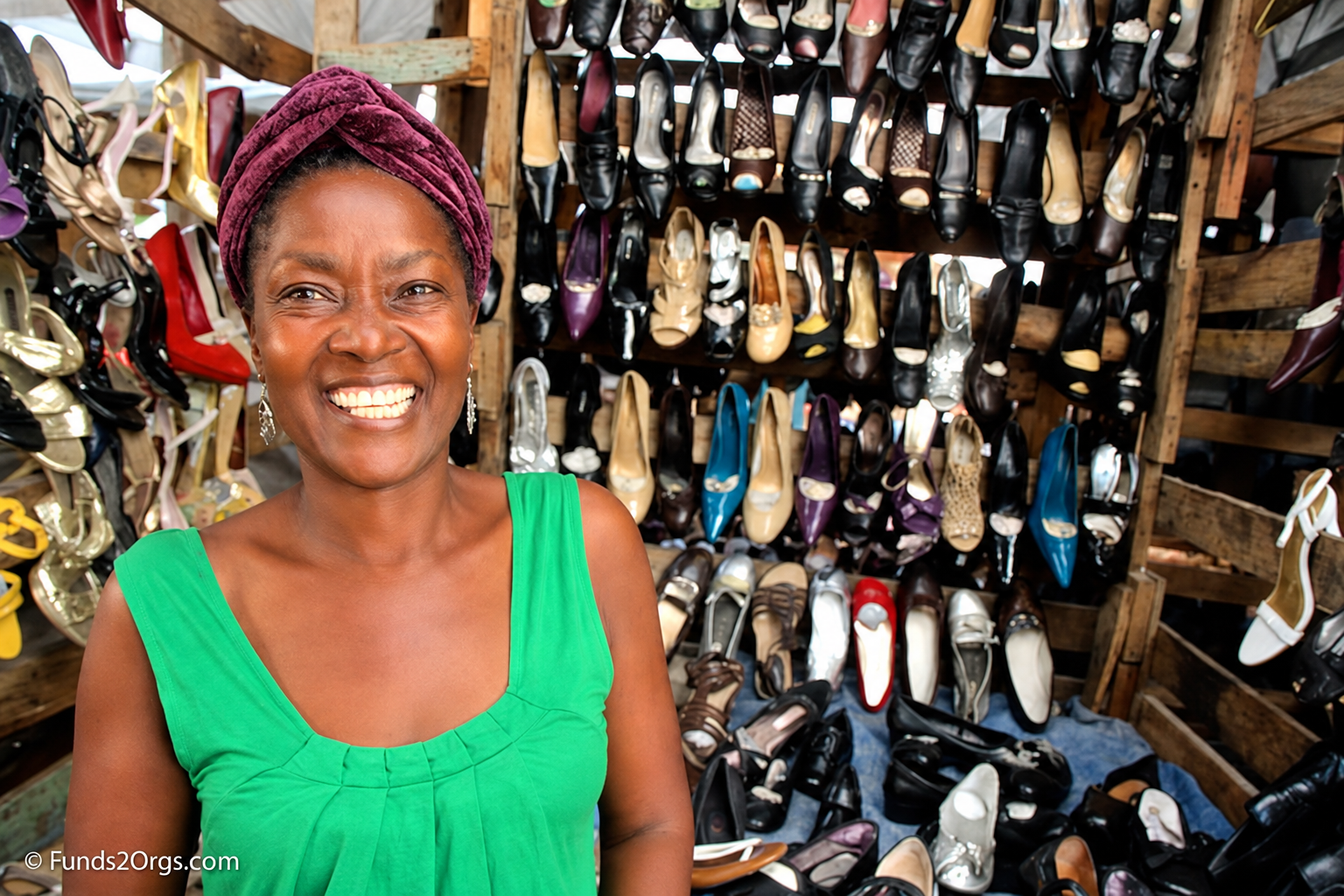 A woman outside her microenterprise shoe store in Haiti.