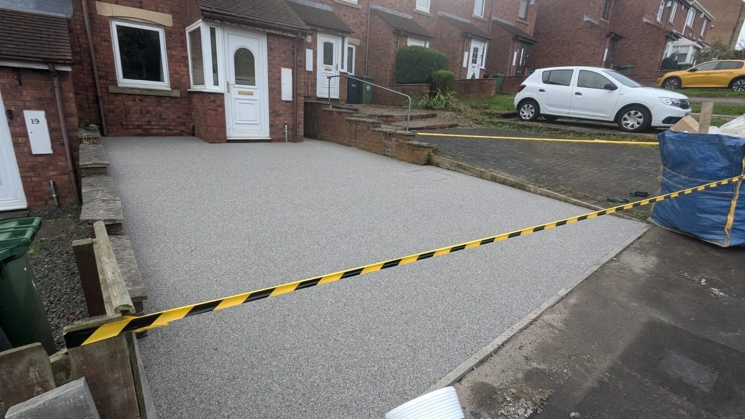 Grey resin driveway, curing behind the tape