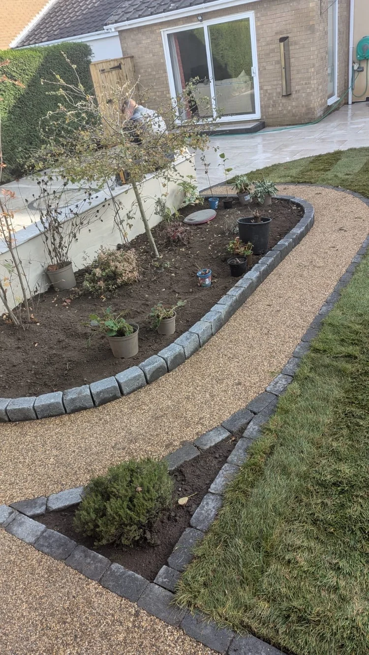 Curved gravel path edged with block kerbs