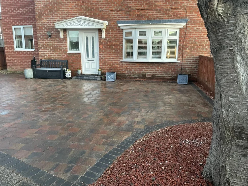 Brindle block paving driveway with a charcoal border and red chip bed