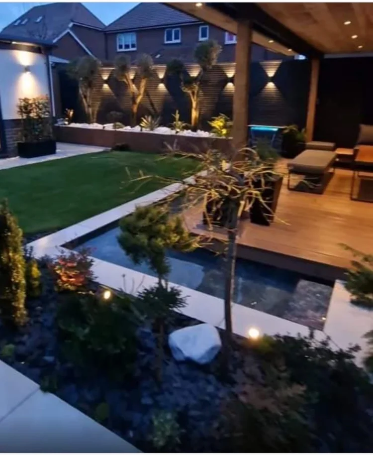 Contemporary garden with a water feature and lighting