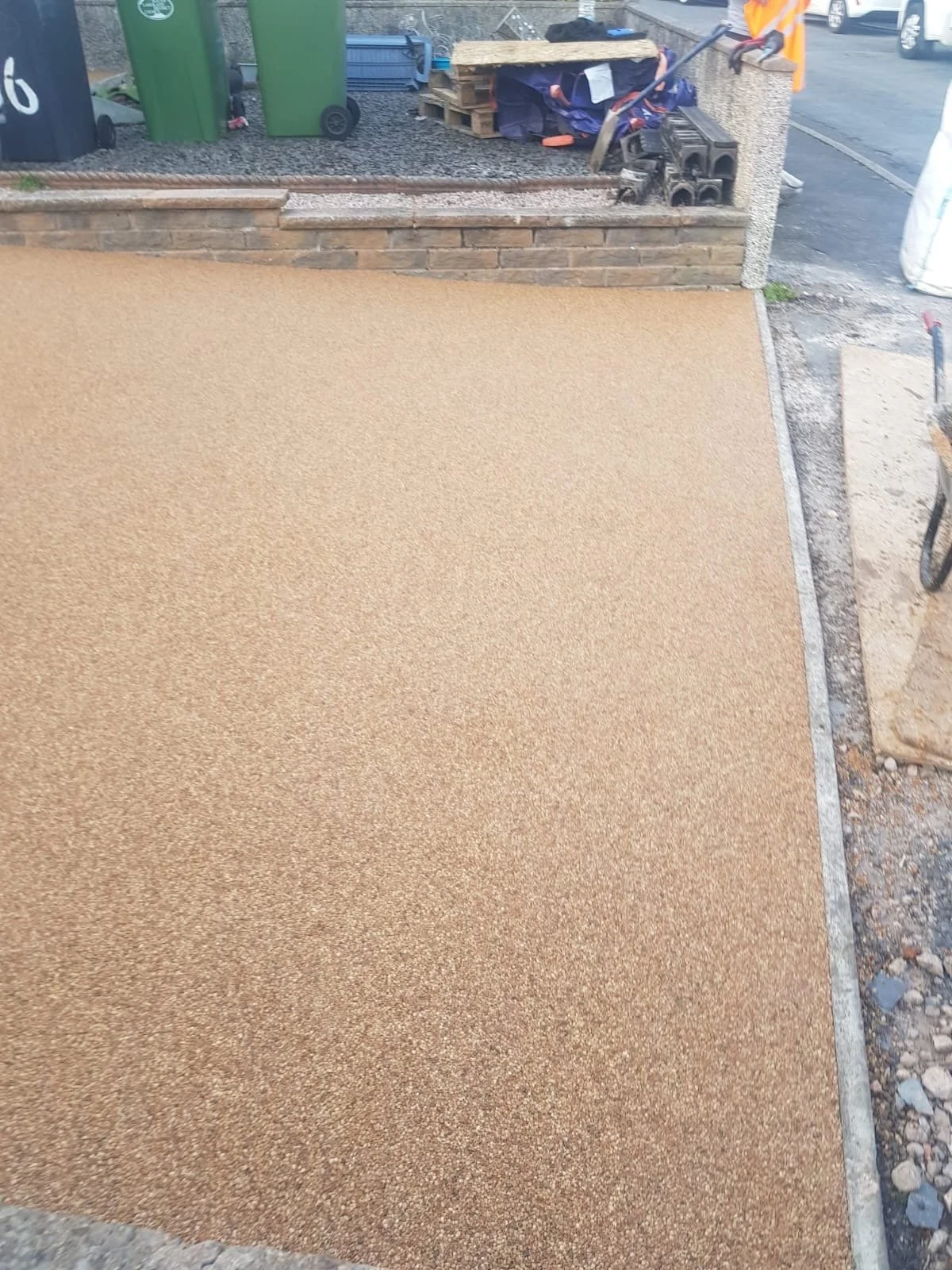 Golden resin-bound driveway being finished