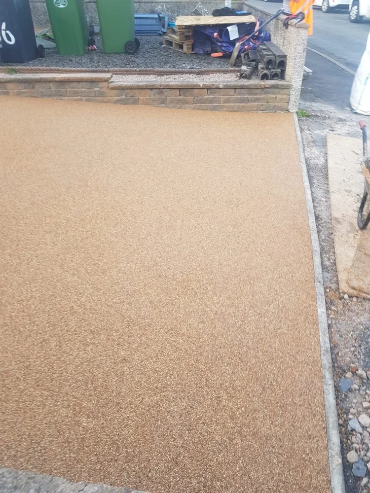 Golden resin-bound driveway being finished