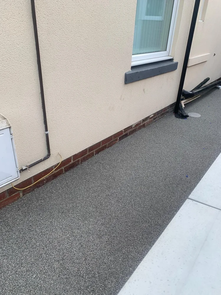 Grey resin path along the side of the house