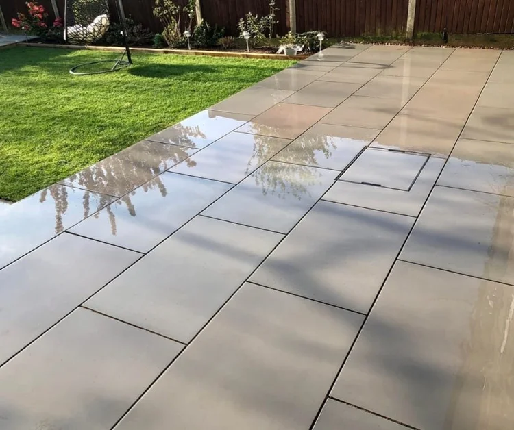 Large-format porcelain slabs meeting the lawn