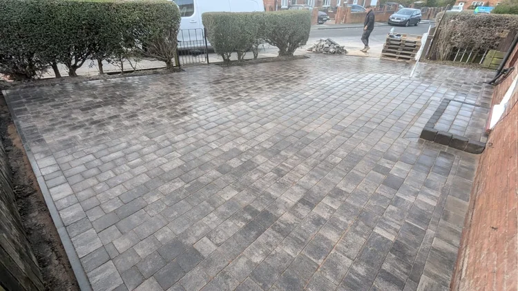 Charcoal block-paved driveway, freshly jointed
