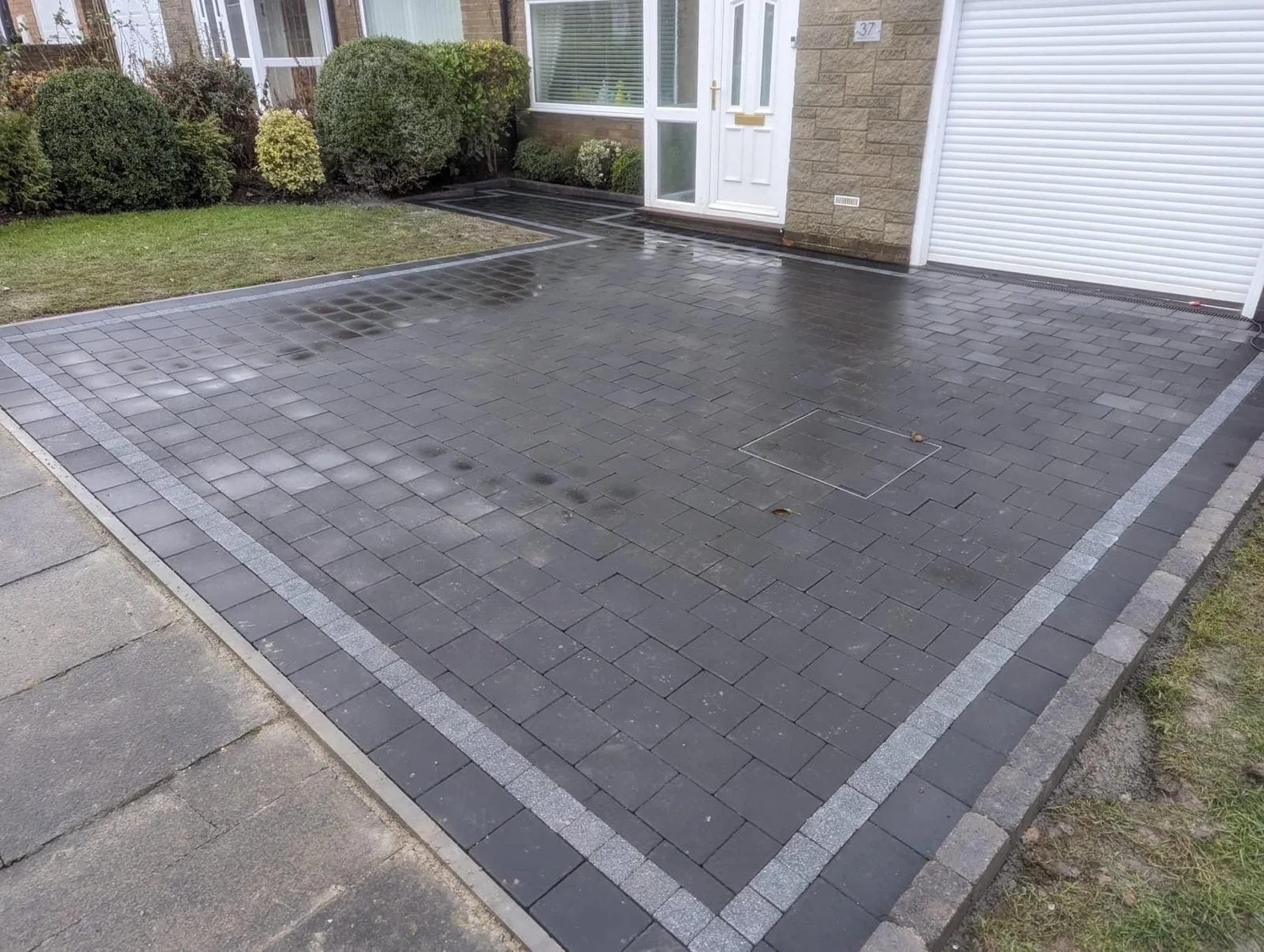 Charcoal block paving with a silver-grey border