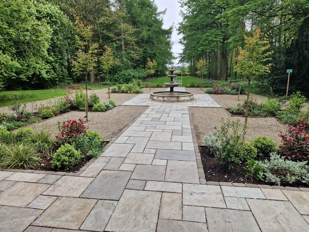 Formal garden with a sandstone path and fountain