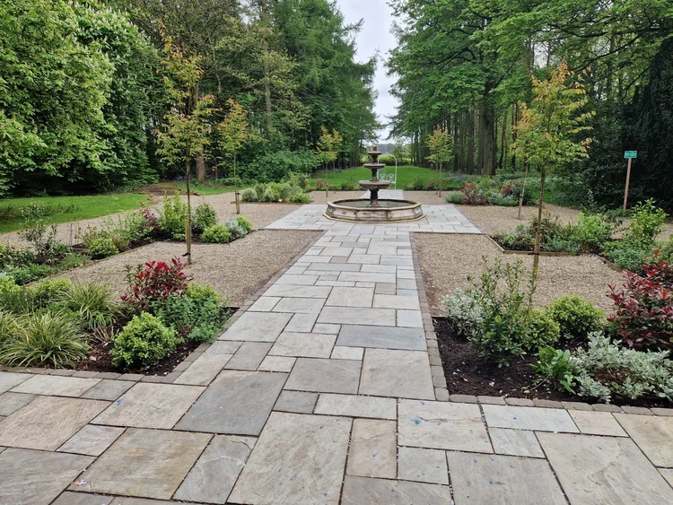 Formal garden with a sandstone path and fountain