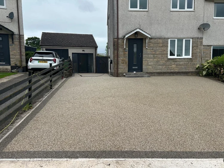 Resin-bound driveway in front of a stone semi