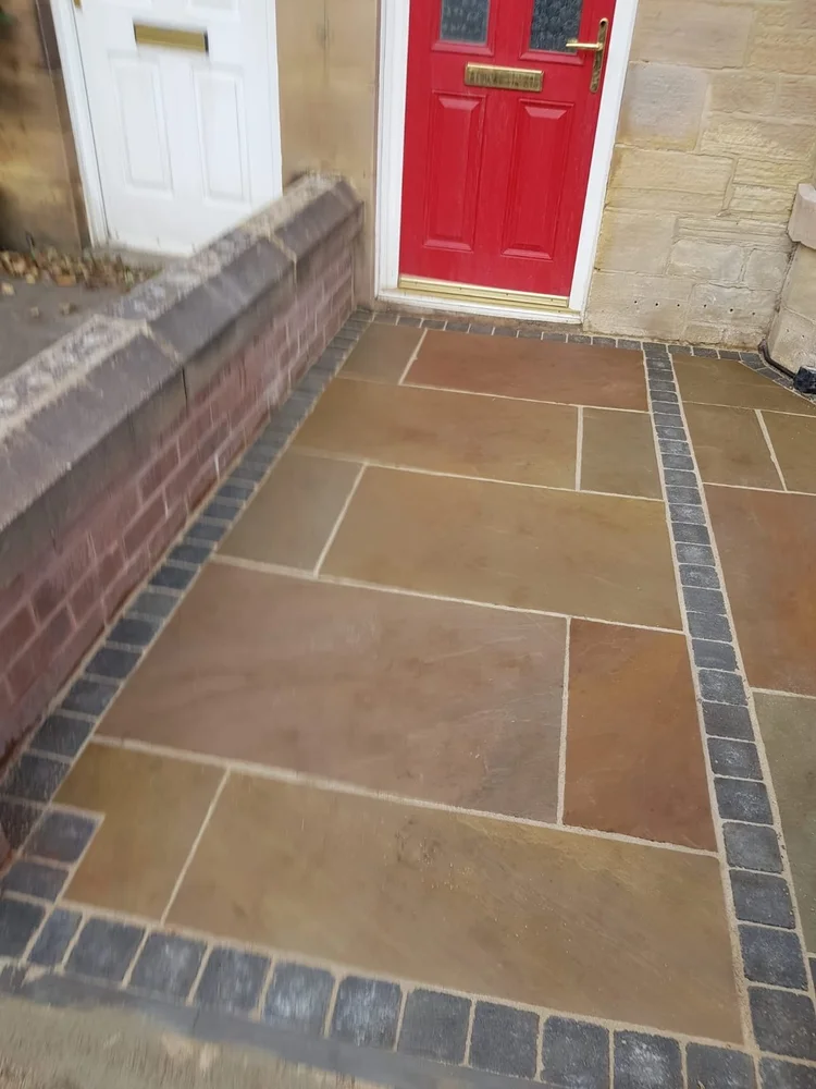 Sandstone front path with a charcoal block border