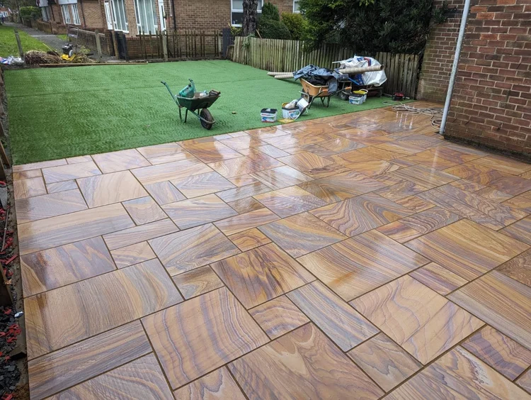 Rainbow sandstone patio with artificial lawn