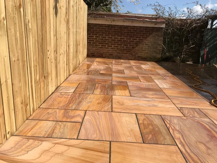 Rainbow sandstone patio against new fencing