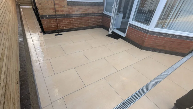 Buff porcelain patio with a linear drain