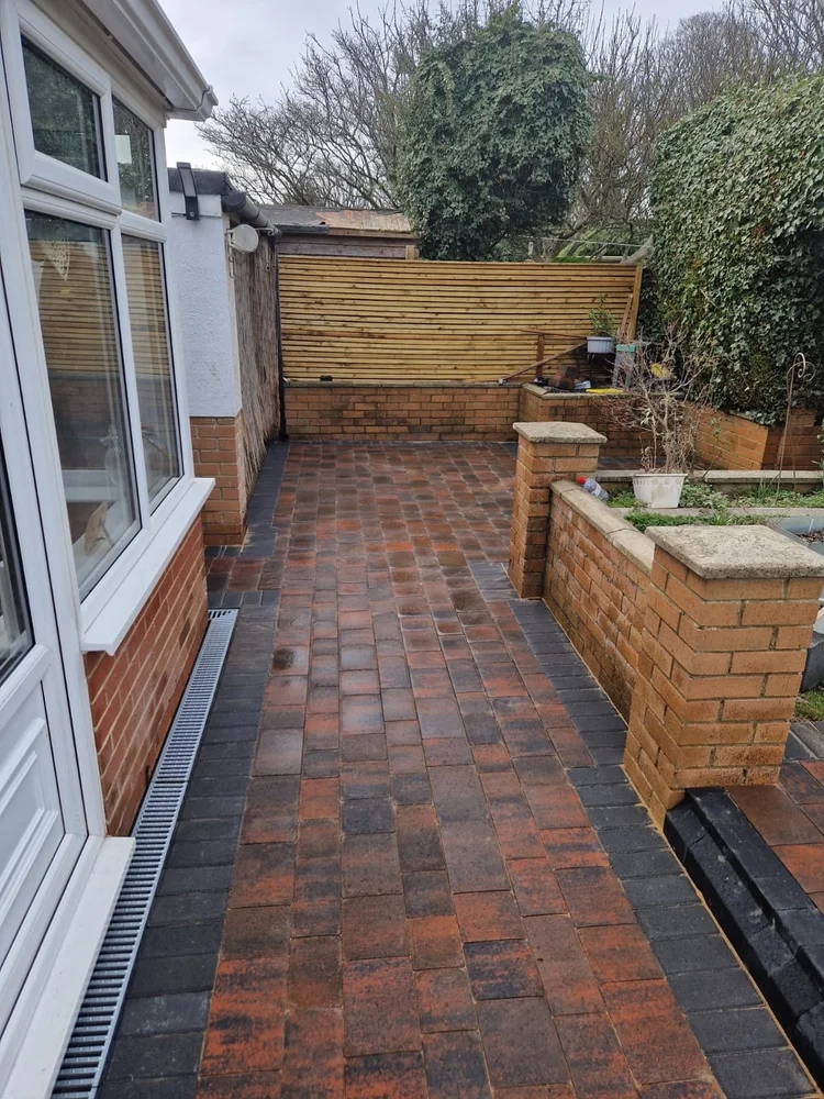 Brindle block path with a drainage channel and brick planters