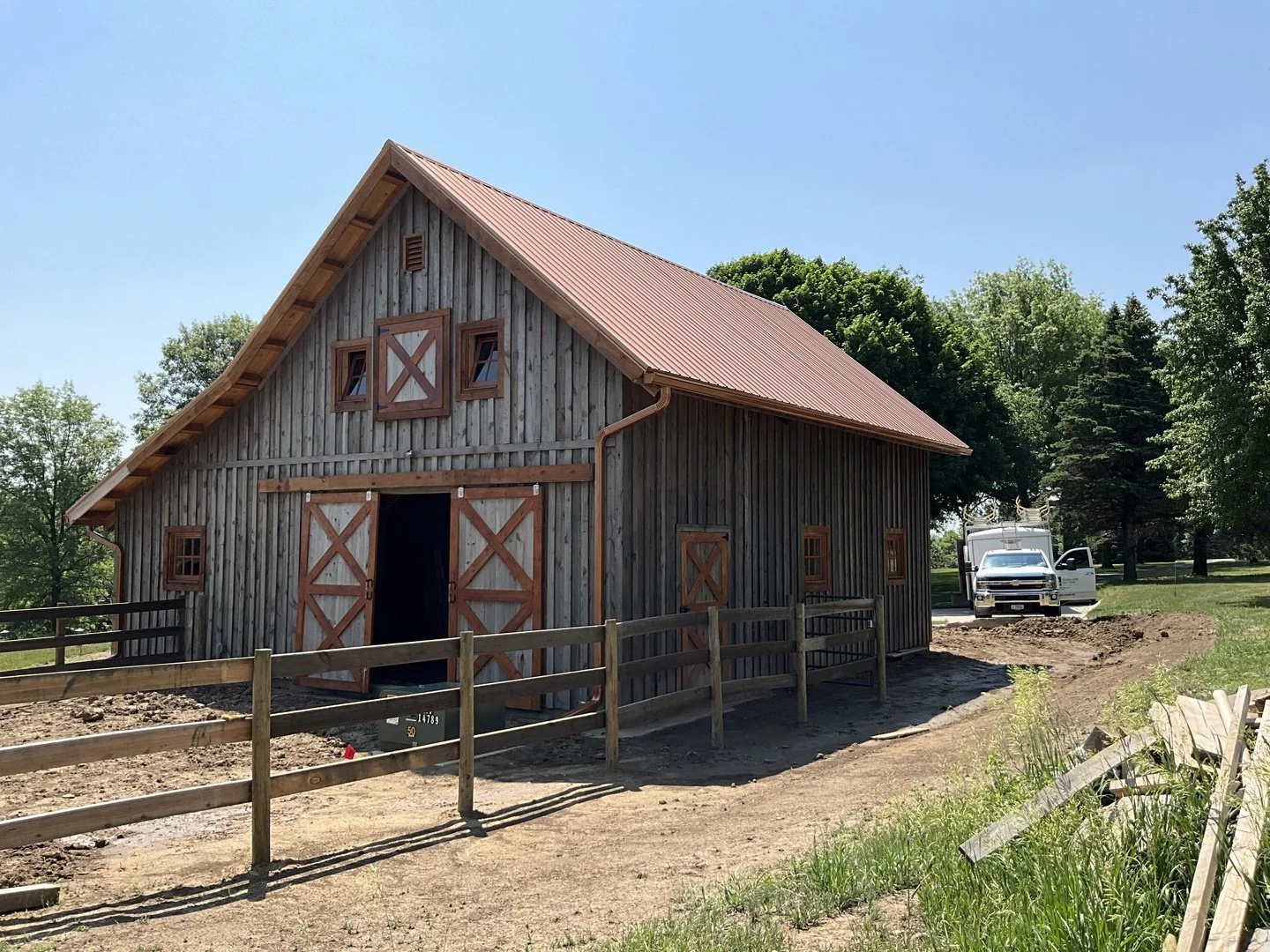 Copper-colored seamless gutters on a horse barn
