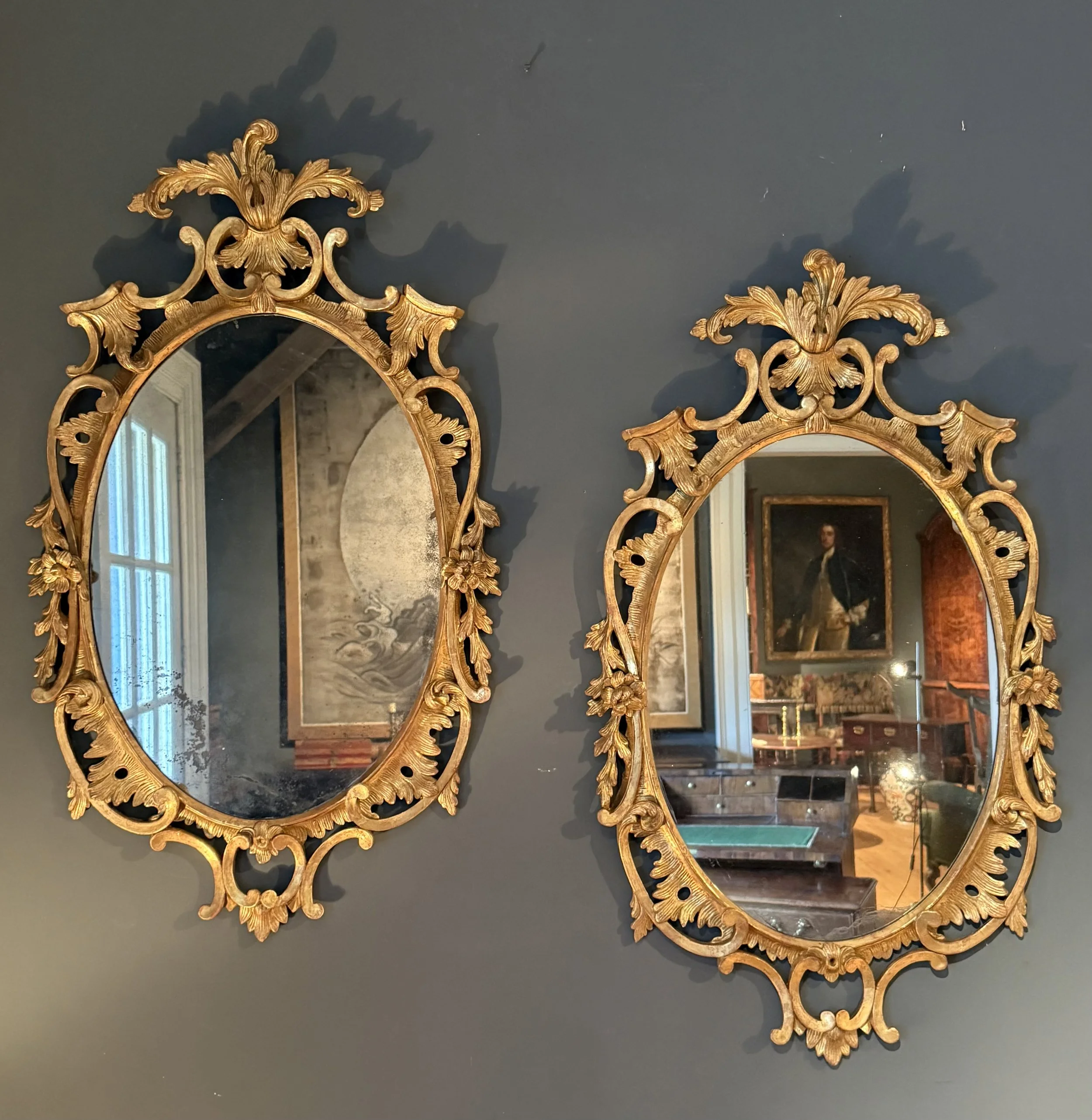 A pair of carved gilwood oval mirrors circa 1760