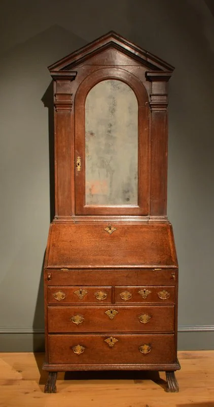 A small George I oak bureau bookcase