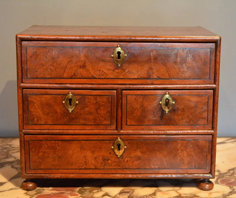 A miniature late 17th Century walnut chest of drawers