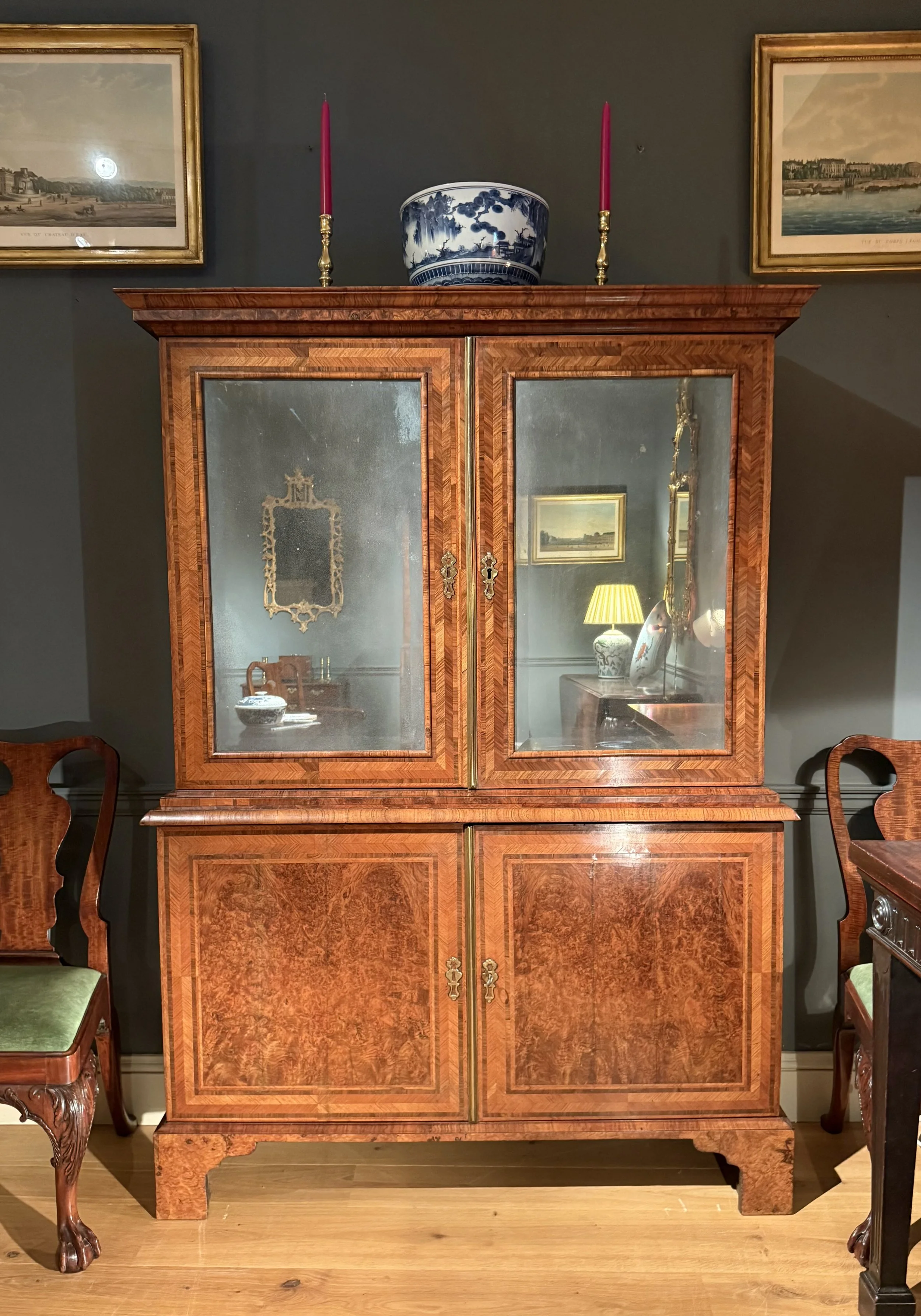 A shallow George II walnut cabinet circa 1730