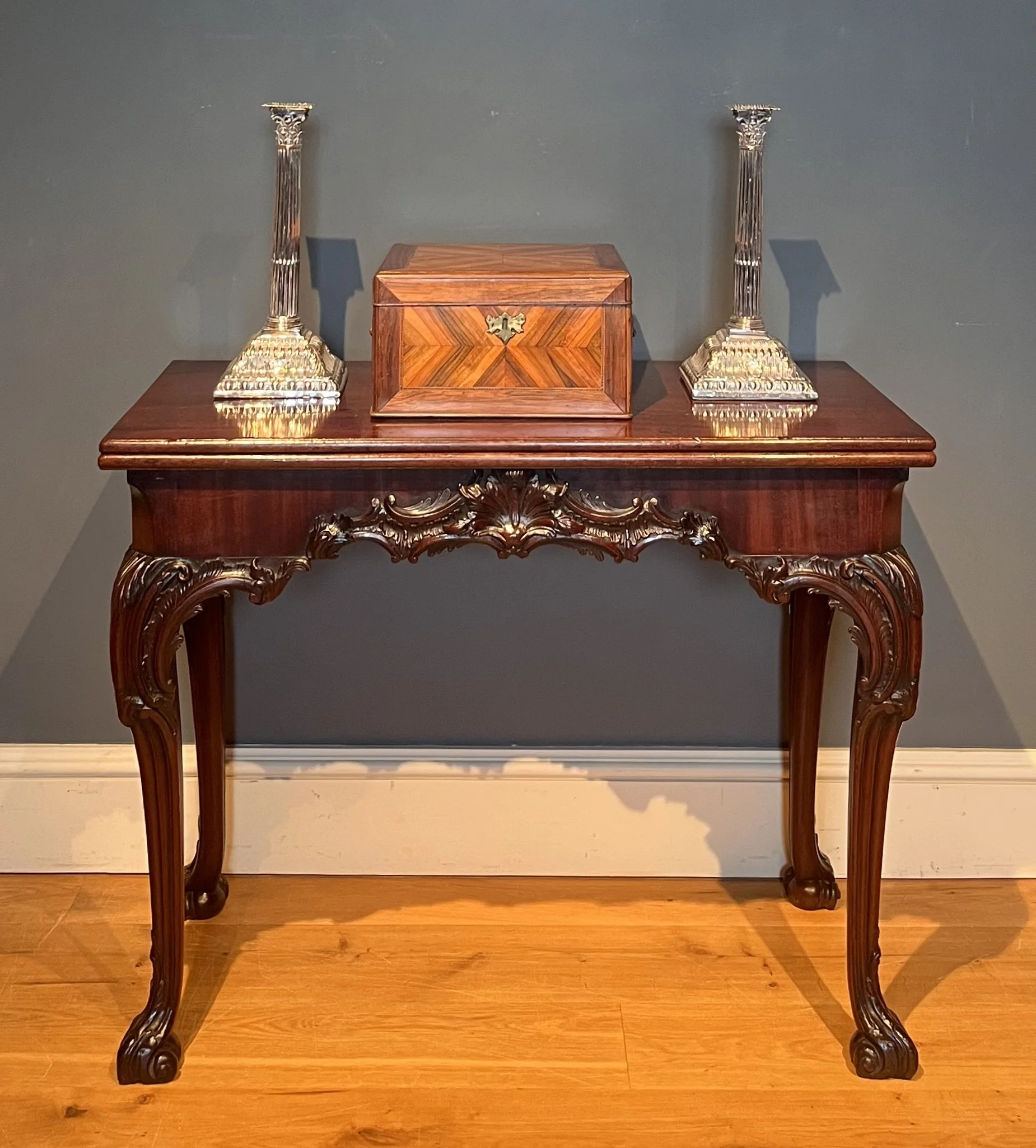 A very fine George II carved mahogany concertina action tea table
