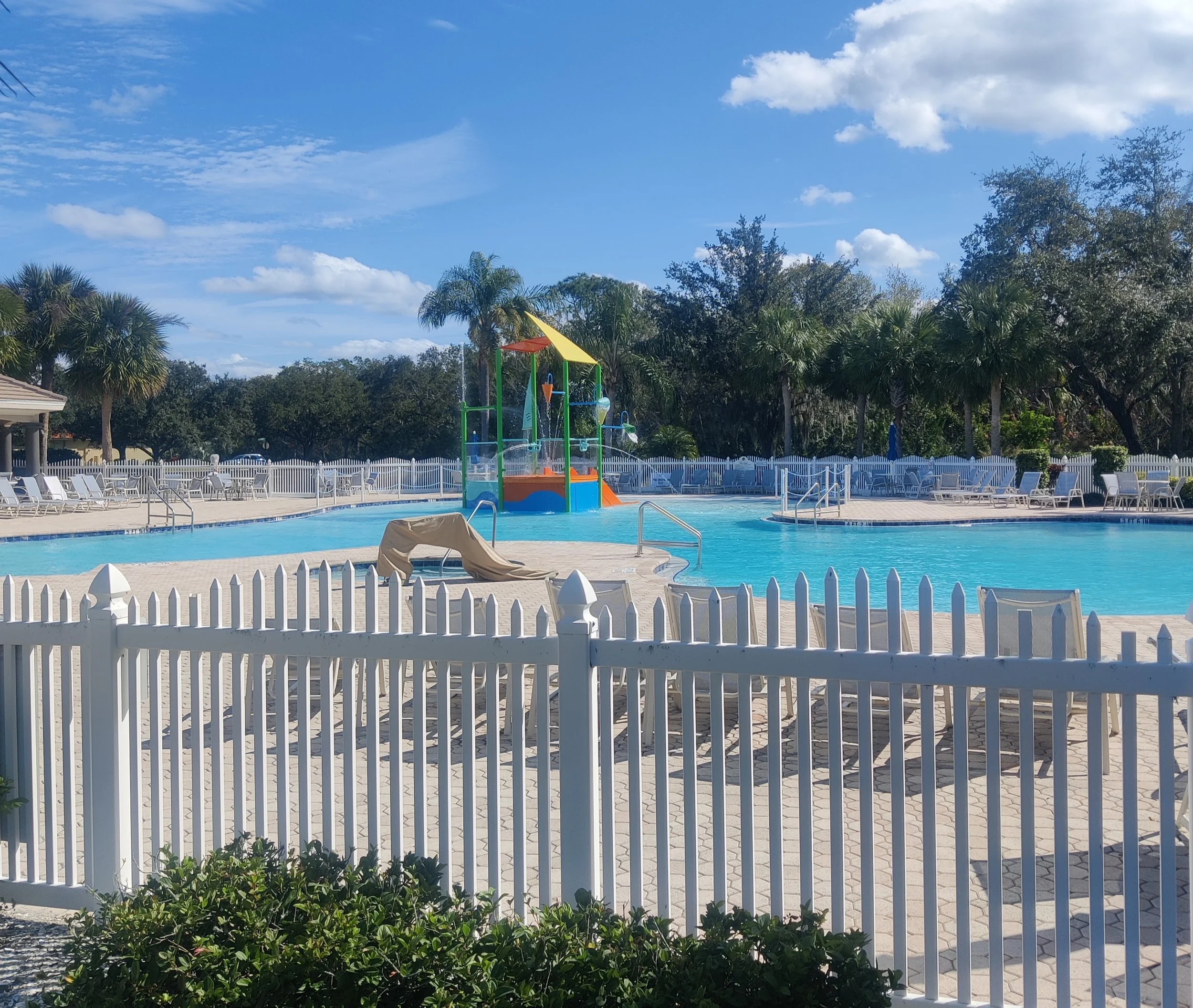 Beautiful Community Pool with splash in water playground.