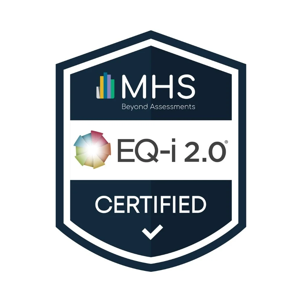 Certification badge with a shield shape featuring a logo with colored bars and a colorful wheel, text reading 'MHS Beyond Assessments', 'EQ-i 2.0', and 'CERTIFIED'.