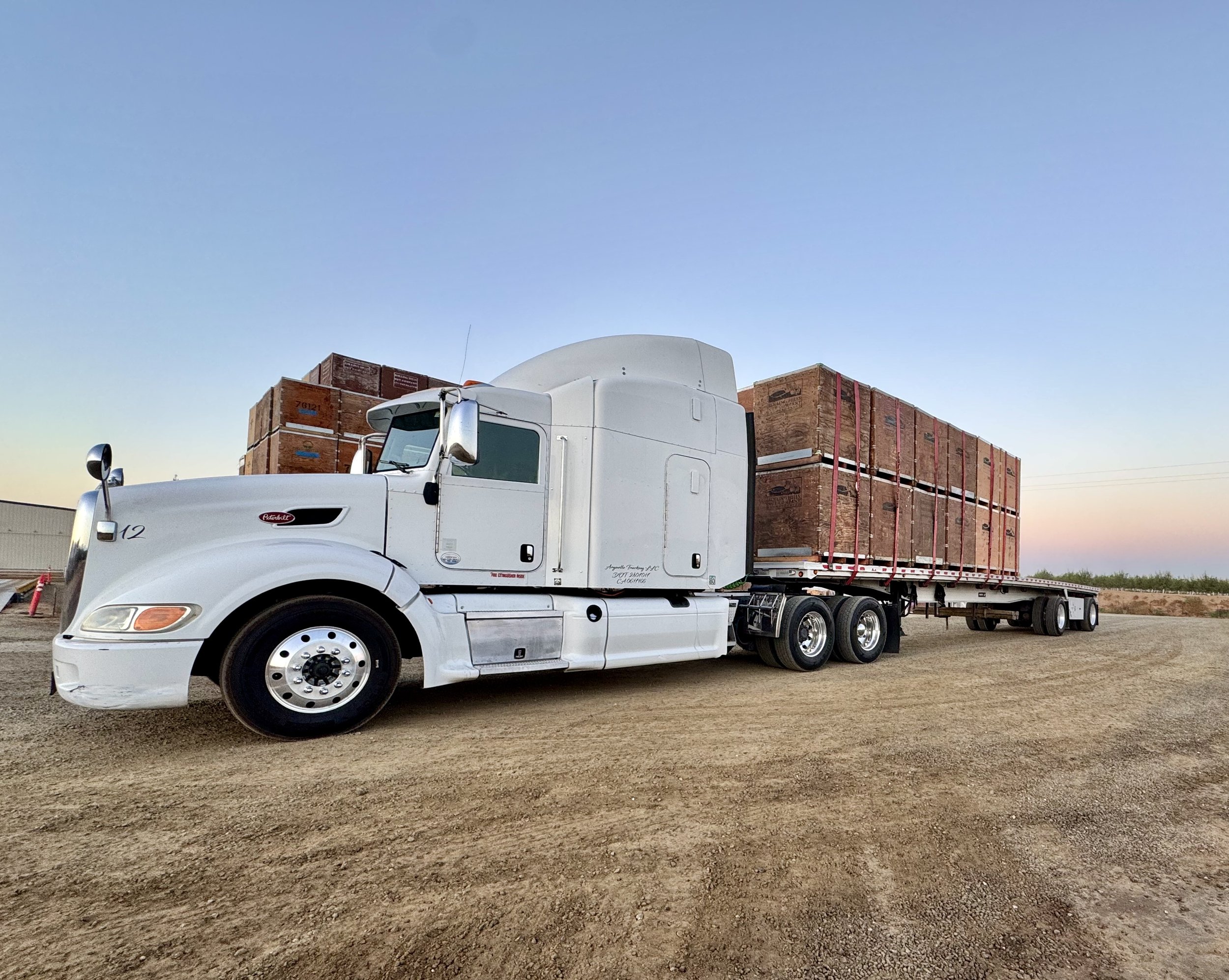 Arguello Trucking Peterbilt hauling a loaded 48-foot flatbed trailer in California’s Central Valley.