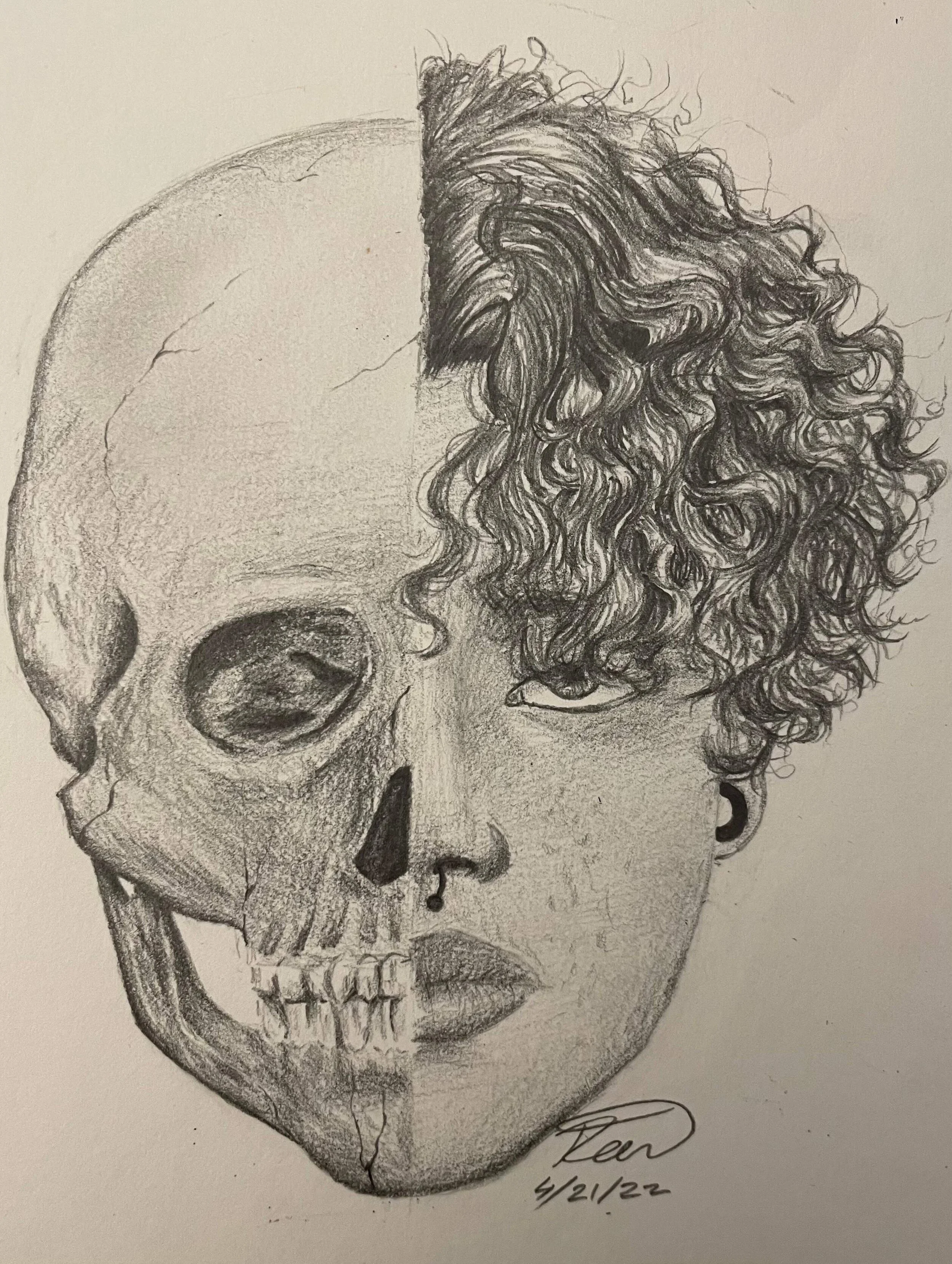 A graphite self-portrait merging Ren Rivera Velez’s face with a human skull, using anatomical detail and textured curly hair to explore identity, mortality, and self-image.