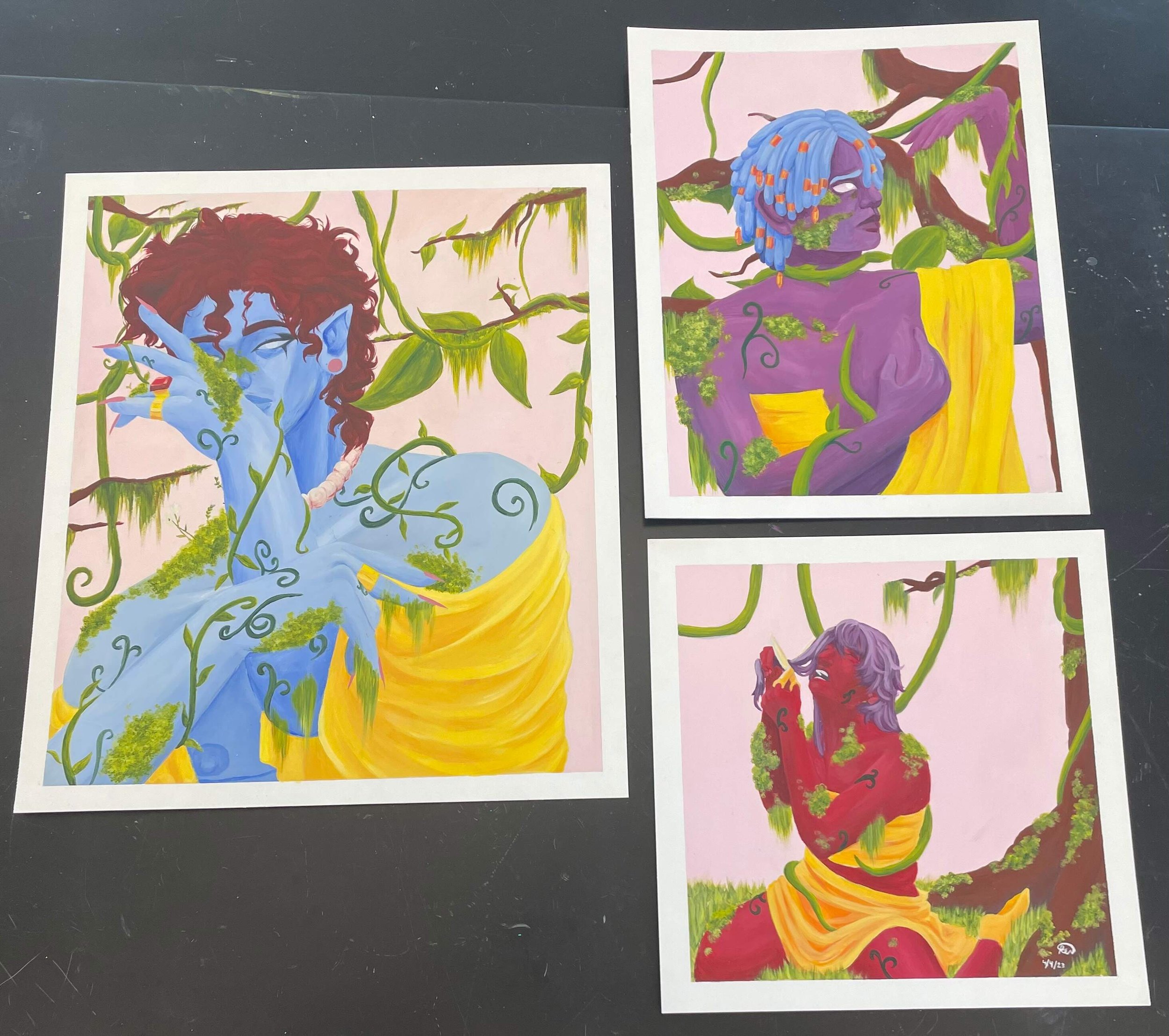 Colorful paintings of mythical characters intertwined with green vines on paper. One character has purple skin and blue hair, and the other has red skin and purple hair, both surrounded by vibrant foliage and nature elements.