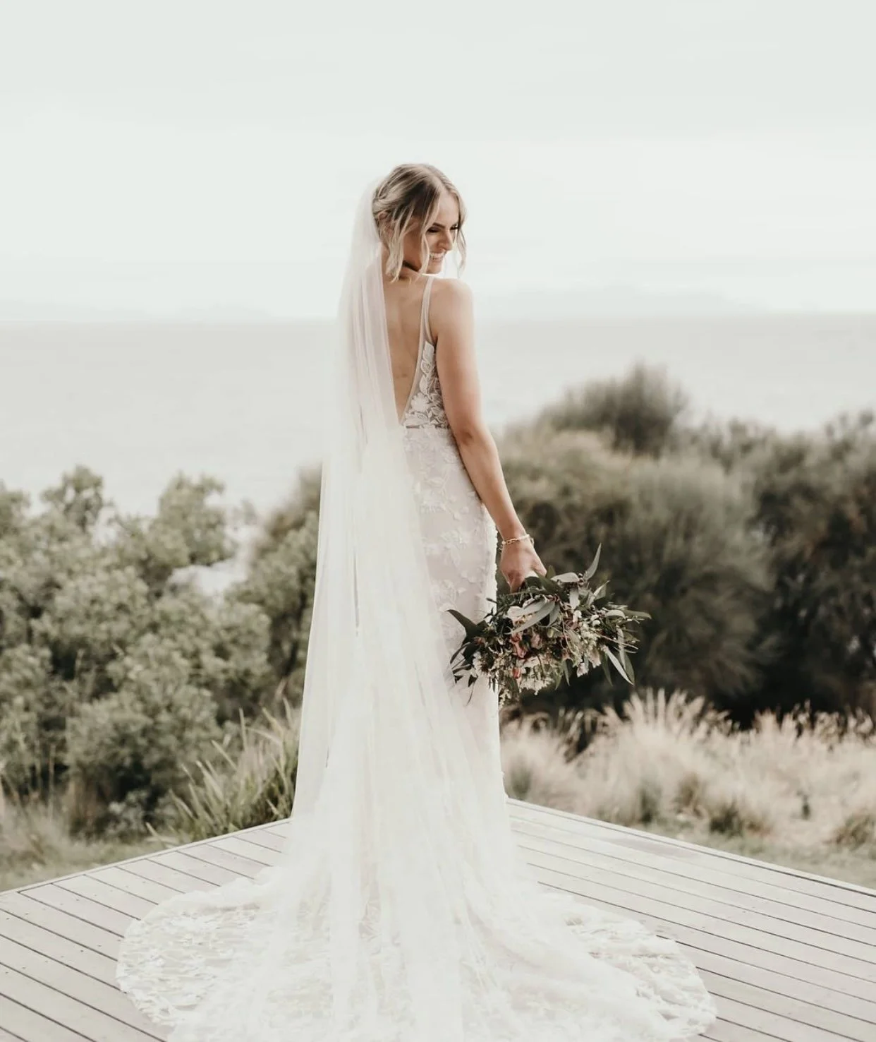 Bride holding her bouquet after having bridal makeup complete.