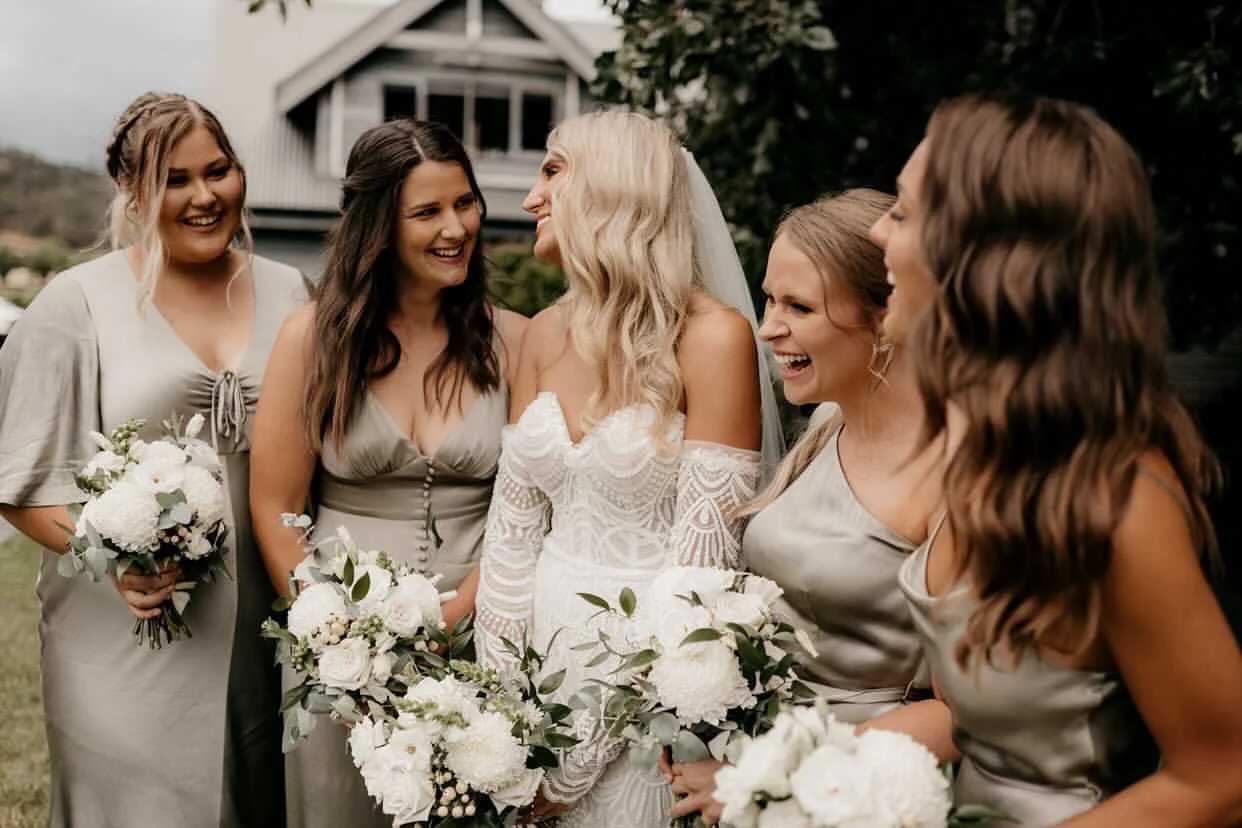 Bride and bridesmaids celebrating together at an outdoor Tasmanian wedding.