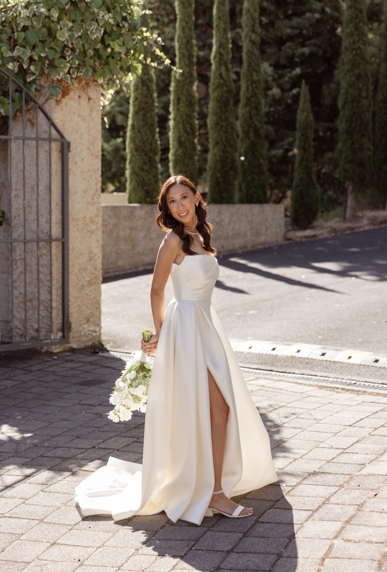 Tasmanian bride in her wedding dress holding a white floral bouquet.