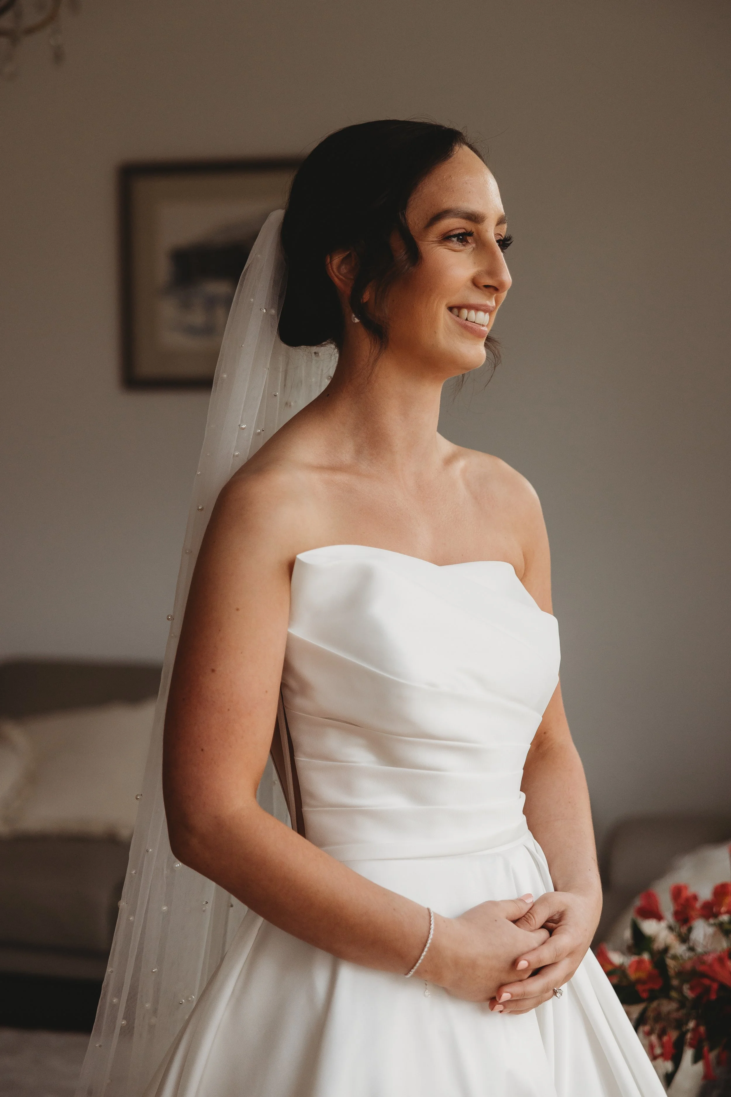 Bride wearing soft, natural bridal makeup with a strapless wedding gown. 