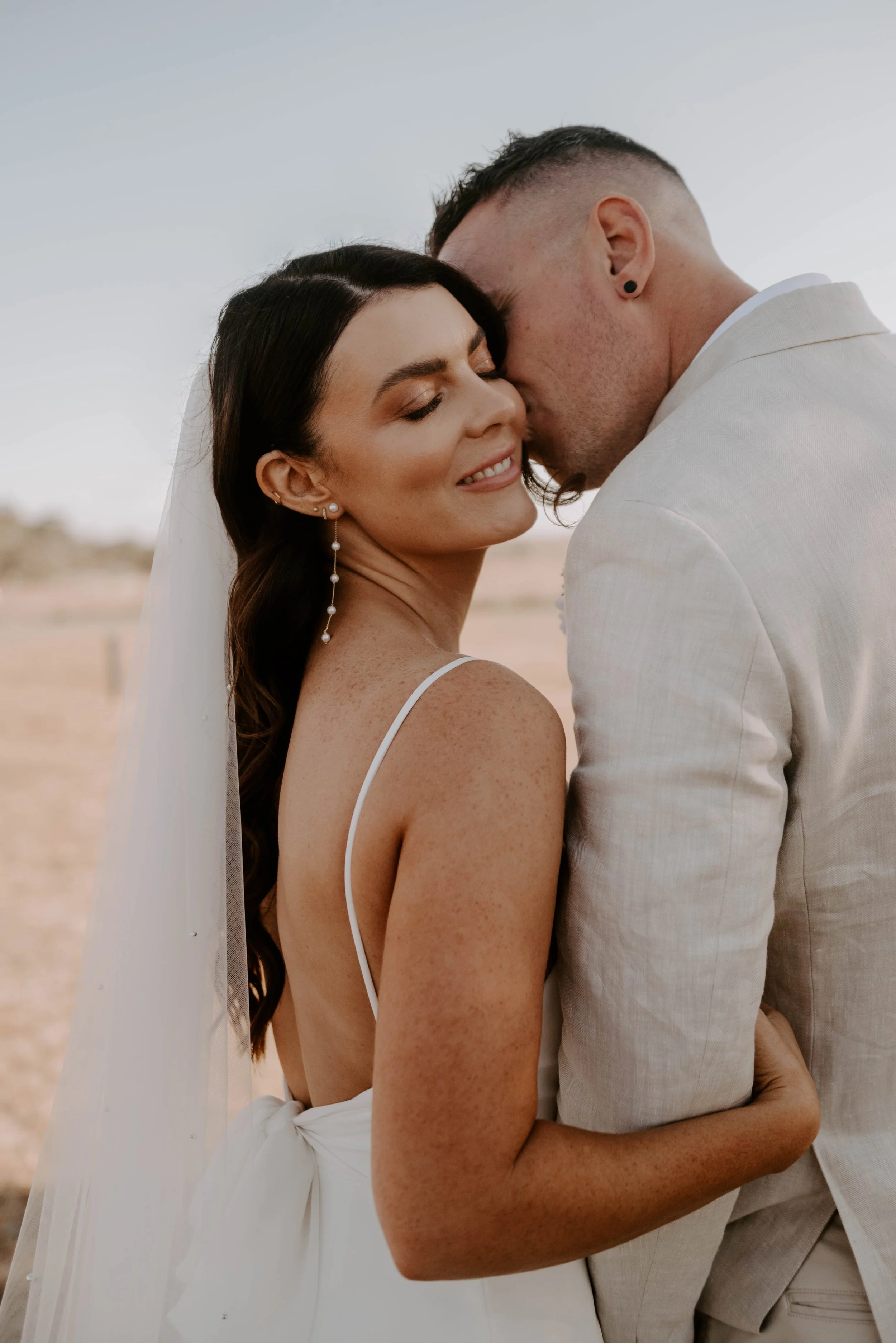 Bride and groom sharing a kiss on their wedding day.