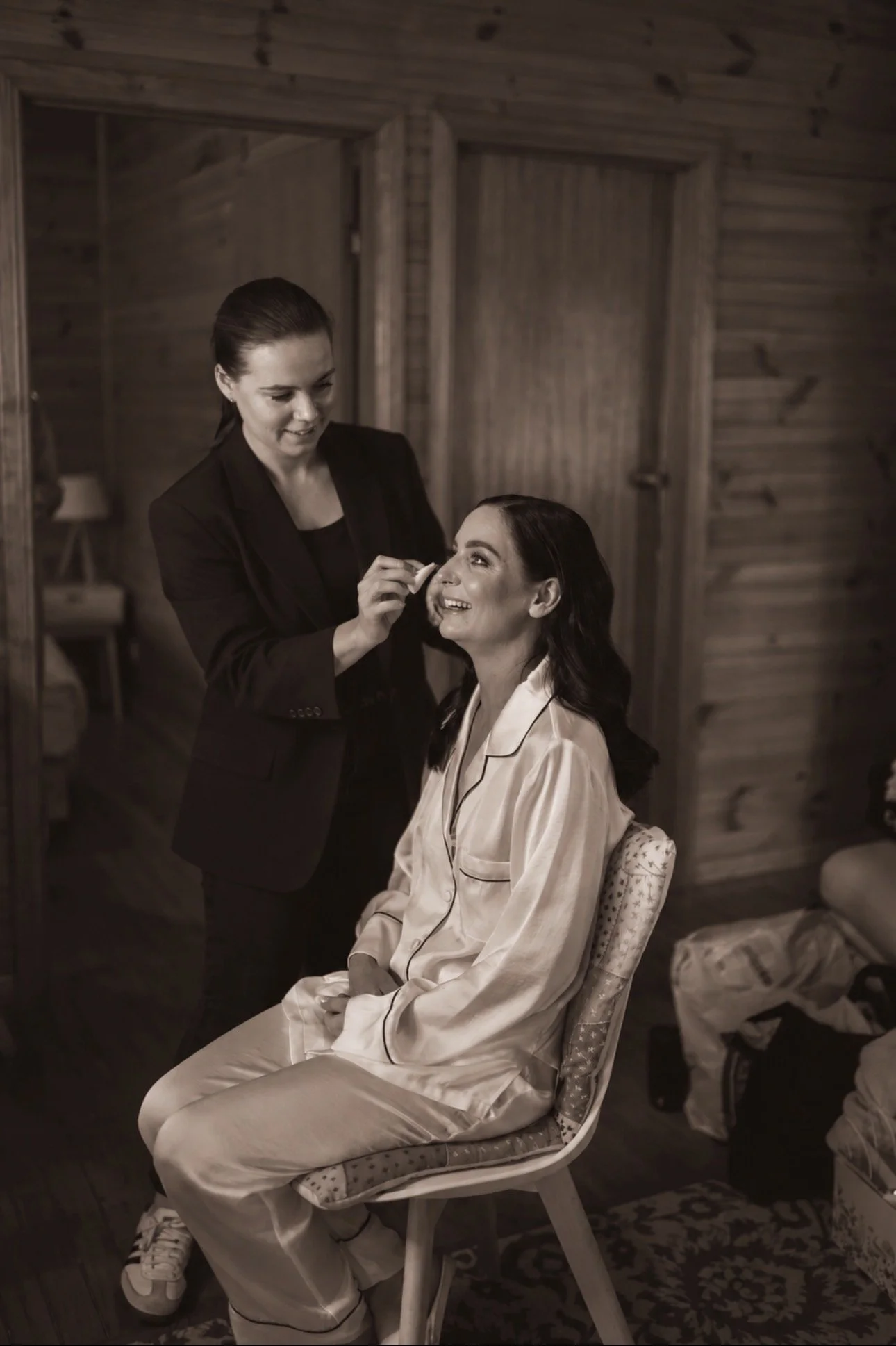 Bride having her makeup applied while getting ready on her wedding morning.
